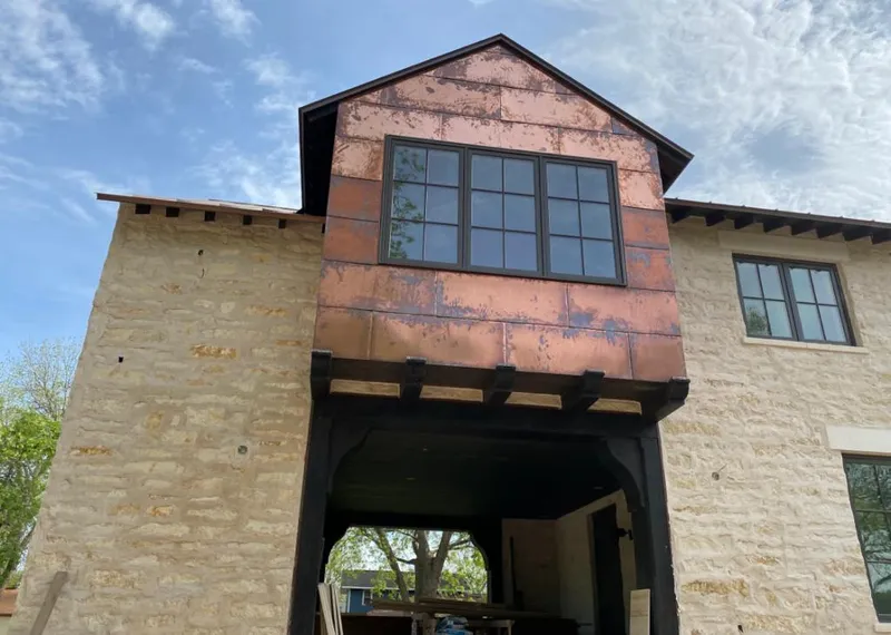 Copper metal panel facade on a stone building for Skylight Installation in Fontana